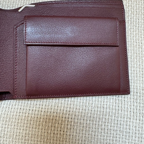 Cartier wallet. NWOT Brown exterior, burgundy interior. Shopping bag included. - Picture 6 of 10